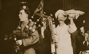 Scottish piper introduces the haggis to a Caledonian Banquet, London by English Photographer
